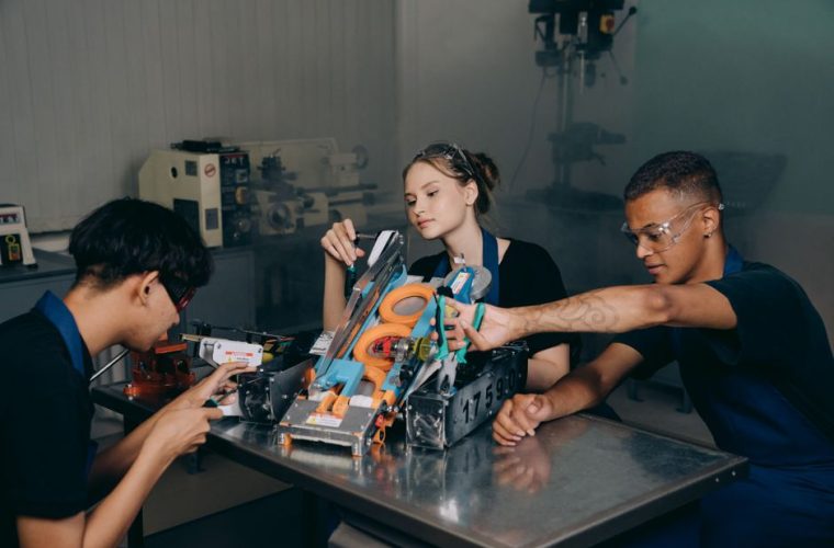 Students engaged in assembling a robotics project in an educational lab setting.